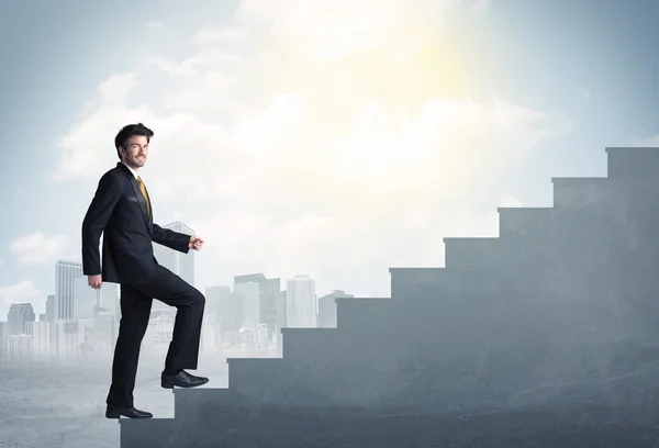 Businessman climbing up a concrete staircase concept — Stock Photo, Image