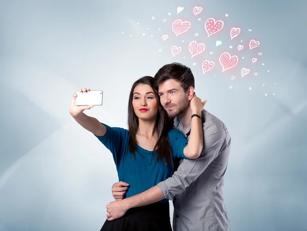 Couple in love taking selfie with red heart — Stock Photo, Image