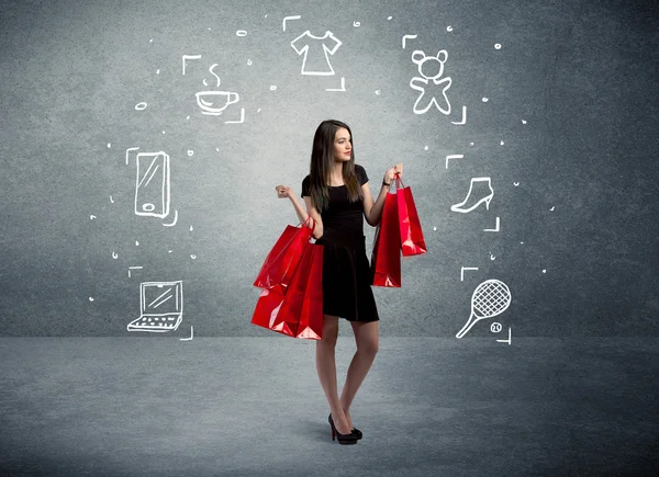 Shopping-Weibchen mit Taschen und gezeichneten Symbolen — Stockfoto