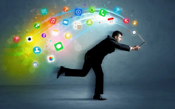 Running businessman with application icons from device — Stock Photo, Image