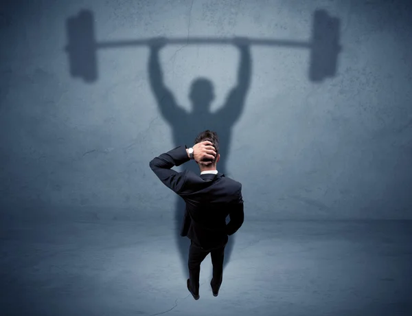 Businessman with weight lifting shadow — Stock Photo, Image