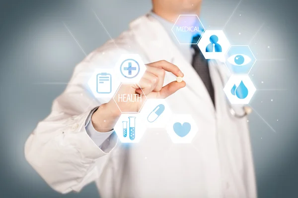 A doctor in white holding a pill — Stock Photo, Image