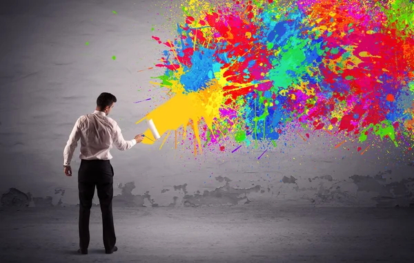 Sales person painting colorful splatter — Stock Photo, Image