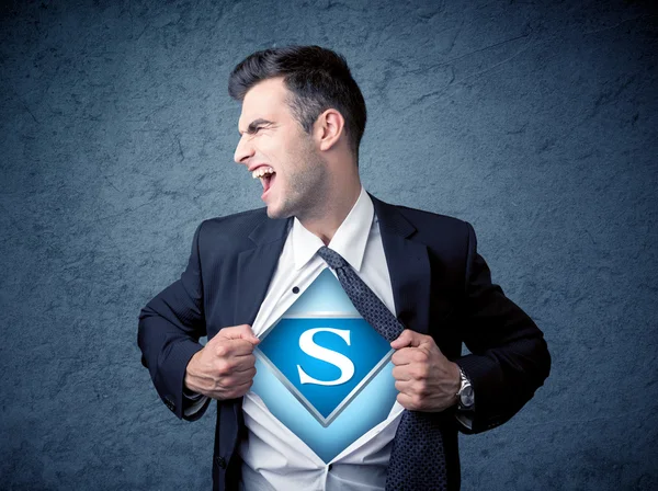 Businessman ripping off his shirt with superhero sign — Stock Photo, Image