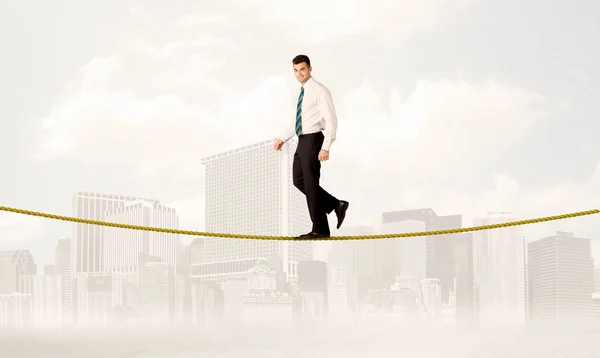 Business person balancing on golden rope — Stock Photo, Image