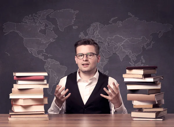 Geography teacher at desk — Stock Photo, Image