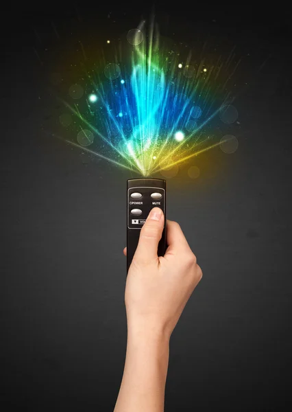 Hand with remote control and explosive signal — Stock Photo, Image