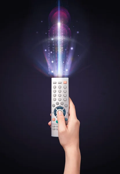 Hand with remote control and shining numbers — Stock Photo, Image