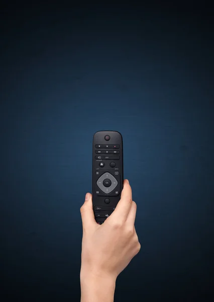 Hand with remote control — Stock Photo, Image