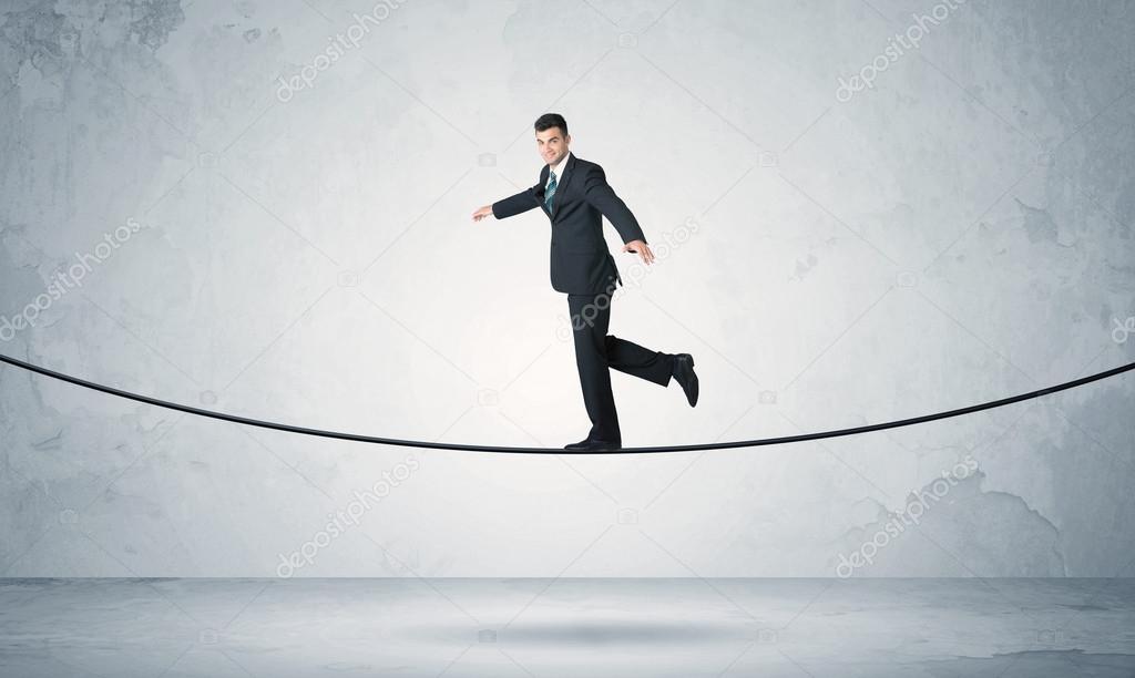 Sales guy balancing on tight rope Stock Photo by ©ra2studio 117872018