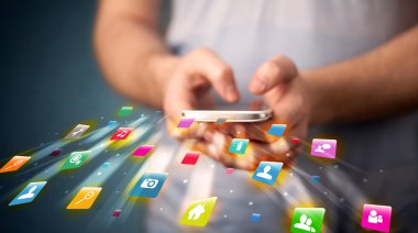 Teknoloji uygulama simgeleriyle akıllı telefon tutan adam
