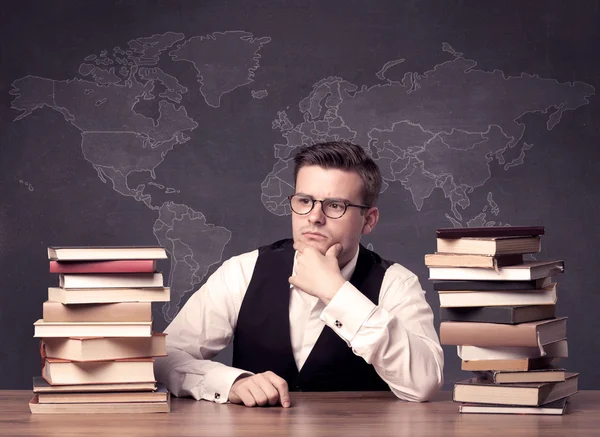 Geography teacher at desk — Stock Photo, Image