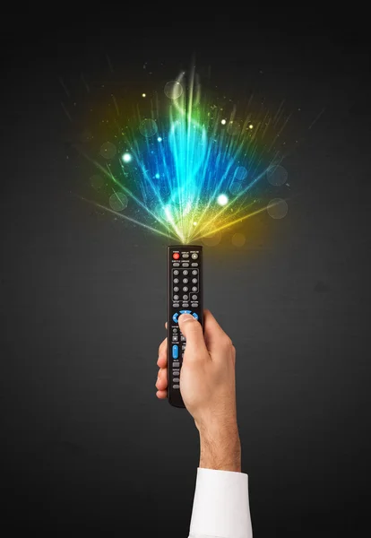 Hand with remote control and explosive signal — Stock Photo, Image