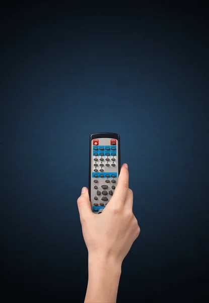 Hand with remote control — Stock Photo, Image