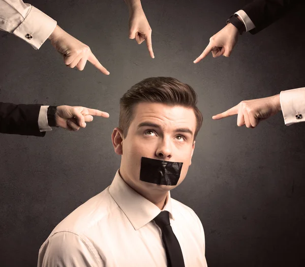 Multiple hands pointing at business employee — Stock Photo, Image