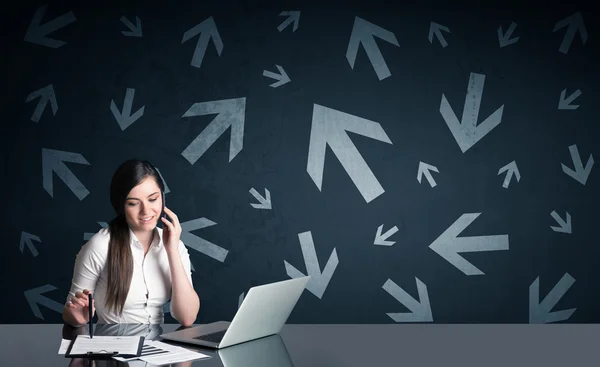 Business woman with arrows in background — стоковое фото