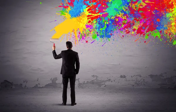 Sales person painting colorful splatter — Stock Photo, Image