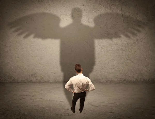 Honest salesman with angel shadow concept — Stock Photo, Image