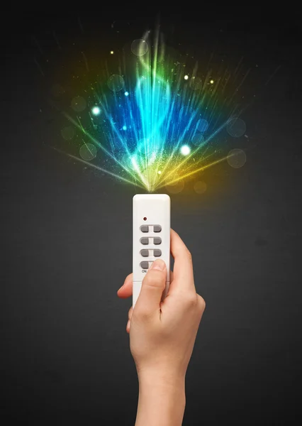 Hand with remote control and explosive signal — Stock Photo, Image