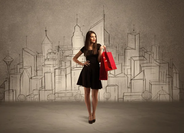 Menina de compras com sacos na cidade desenhada — Fotografia de Stock