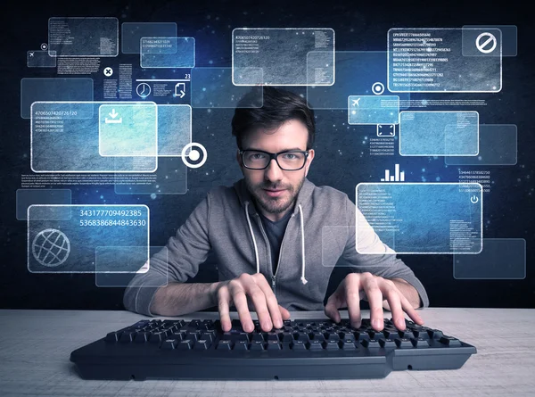 Nerd with glasses hacking websites — Stock Photo, Image