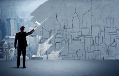 Zarif satıcı şehri duvarda yeniden boyuyor.