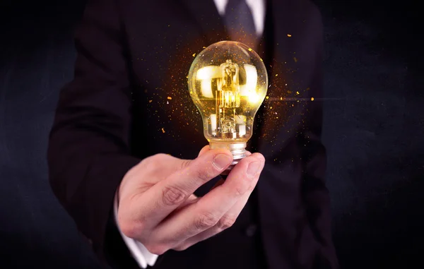 Office worker holding a light bulb — Stock Photo, Image