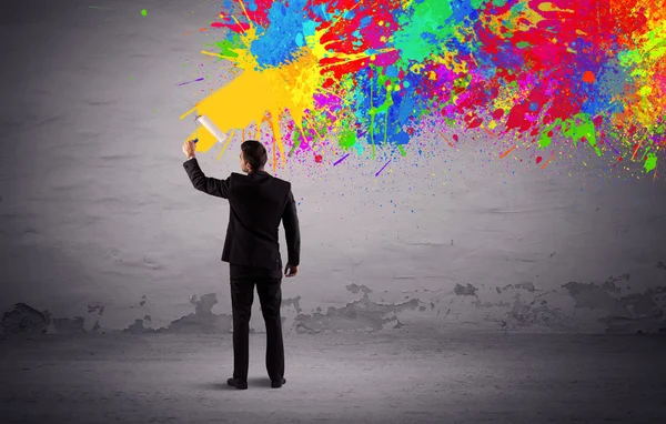 Sales person painting colorful splatter — Stock Photo, Image