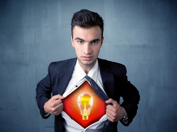 Businessman ripping off shirt and idea light bulb appears