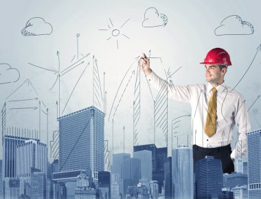 Genç işçi şehir manzarası çiziyor.