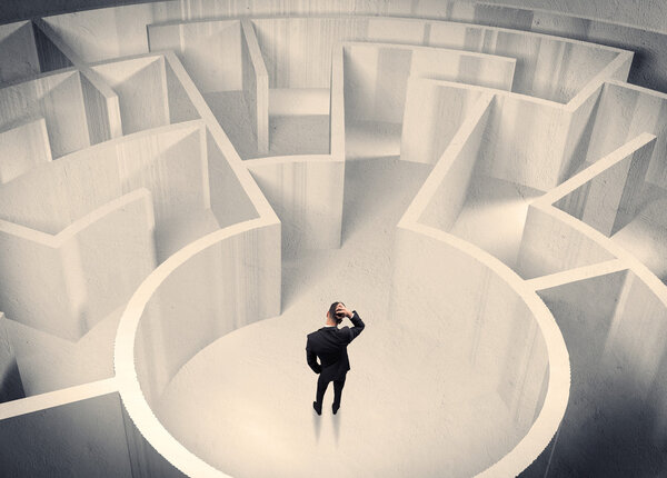 Business person standing in maze center
