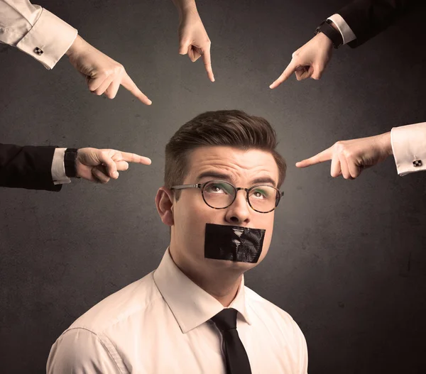 Multiple hands pointing at business employee — Stock Photo, Image