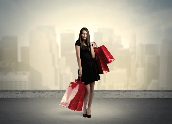 Mujer de la ciudad de pie con bolsas — Foto de Stock