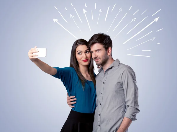 Cute couple taking selfie with arrows — Stock Photo, Image