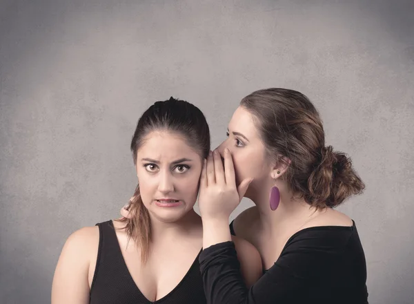 Girl telling secret things to her girlfriend — Stock Photo, Image