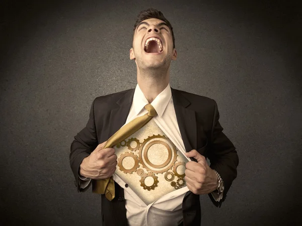 Businessman tearing shirt off and machine cog wheel shows — Stock Photo, Image