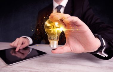 bir ampul tutarak ofis çalışanı