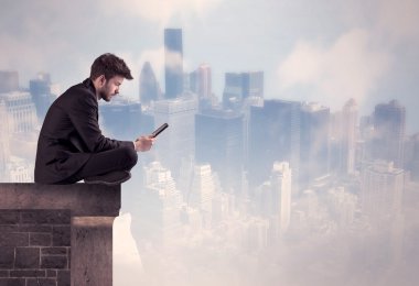 Yüksek bir binanın tepesinde oturan satıcı.