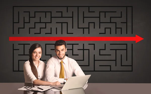 Business couple with a solved puzzle in background — Stock Photo, Image