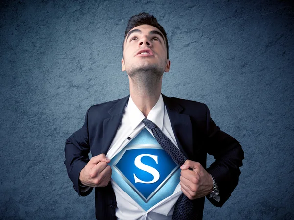 Businessman ripping off his shirt with superhero sign — Stock Photo, Image