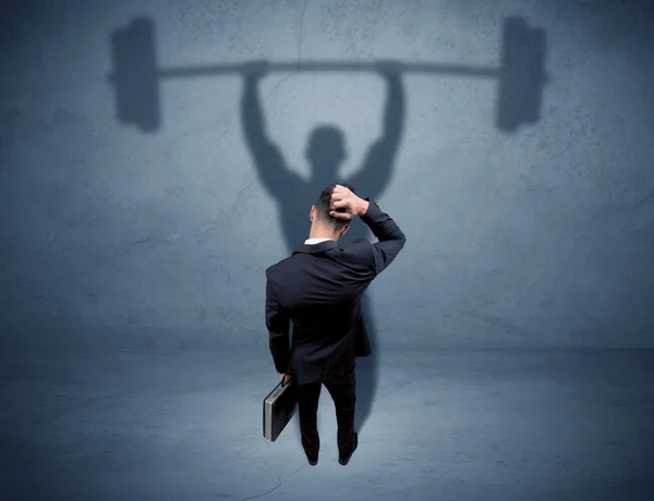 Businessman with weight lifting shadow — Stock Photo, Image