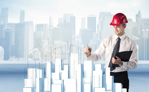 Businessman drawing skyscrapers — Stock Photo, Image