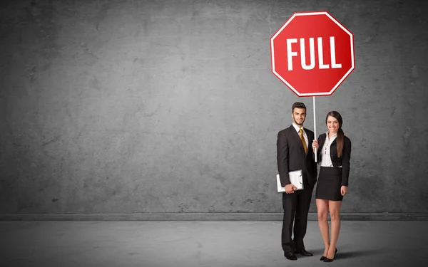 Young business person holding road sign — Stock Photo, Image