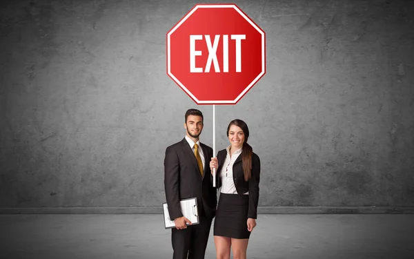 Young business person holding road sign — Stock Photo, Image