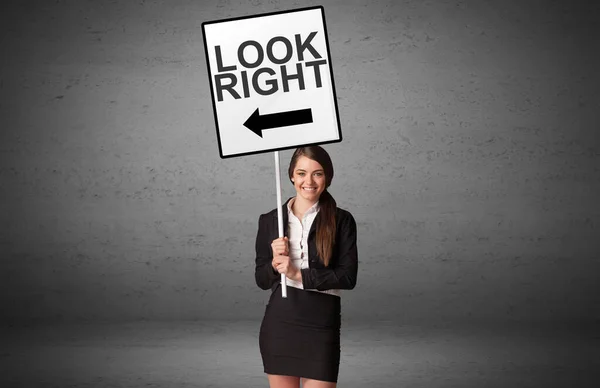 Business person holding a traffic sign — Stock Photo, Image