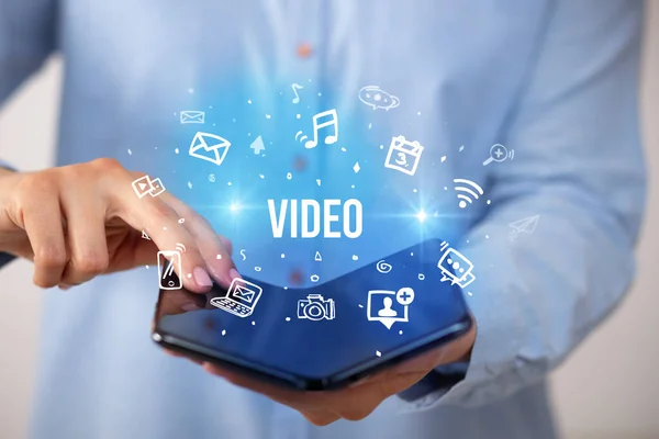 Businessman holding a foldable smartphone, social media concept — Stock Photo, Image