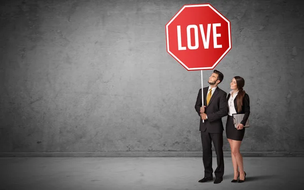 Young business person holding road sign — Stock Photo, Image