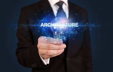 Elinde ampul tutan bir iş adamı.