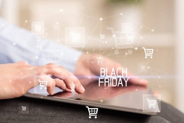 Genç adam tabletle alışveriş yapıyor.