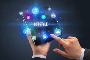 Katlanabilir akıllı telefonu olan bir iş adamı